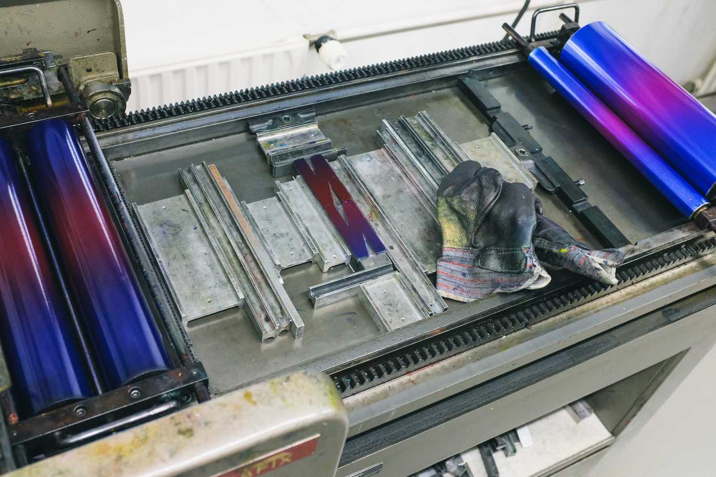 Two narrow N's set on a printing press