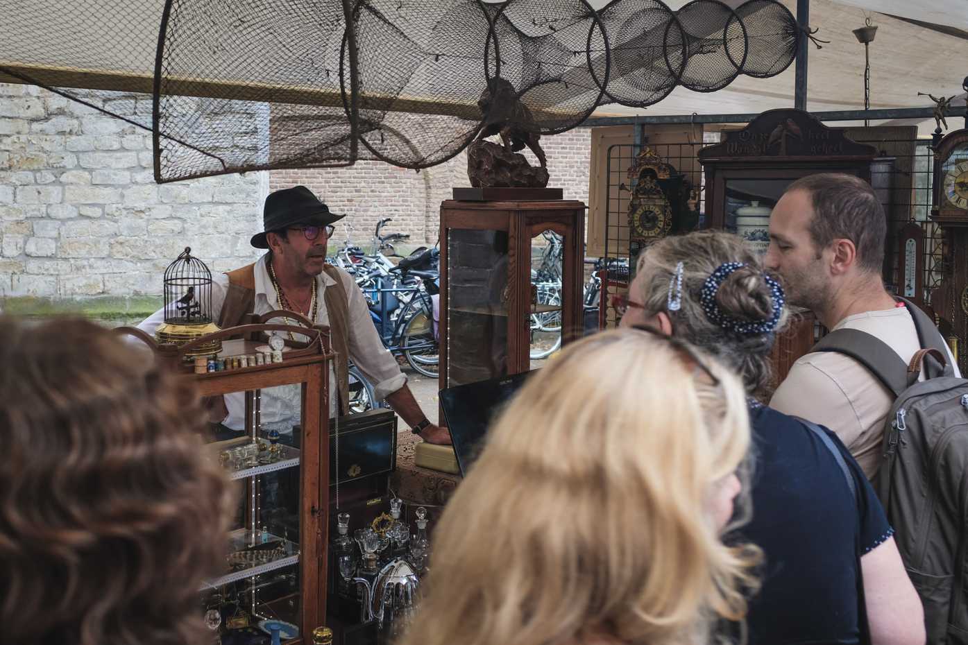 A vendor at an outdoor antiques market